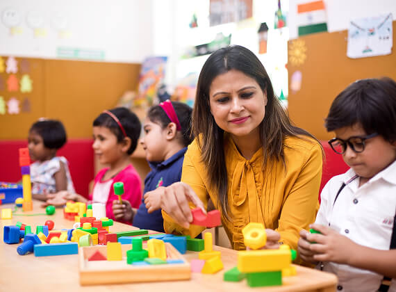 Preschool child building structures in group session